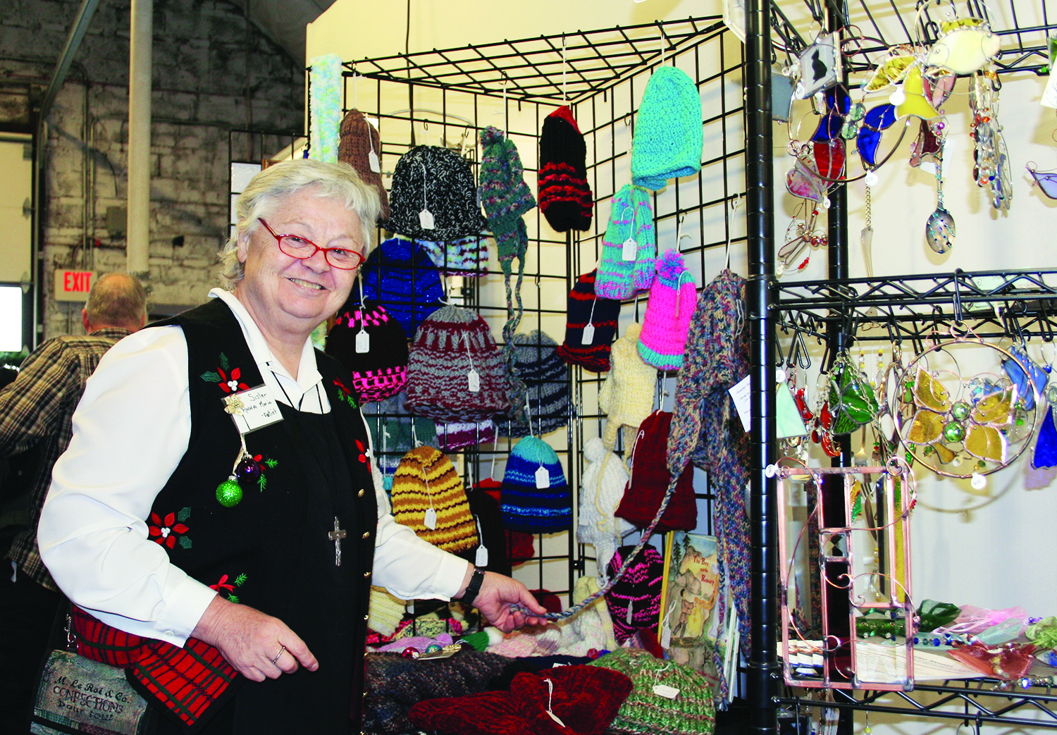 Sister Anna Maria Hayes displays scarfs and hats 