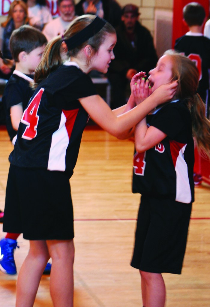 PHOTO BY DEBBIE SADLON Saturday, March 15, 2014, Antioch League Ignatius Basketball Association (IBA) Championship Game (3rd grade boys and 3rd and 4th grade girls), St. Ignatius of Antioch School Gym, 10205 Lorain Ave: (L-R) Kate Boland and Mary McEwen celebrate the Knights’ victory in the Antioch League IBA championship game.