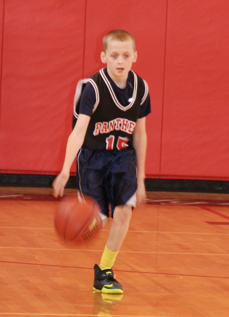 PHOTO BY CHUCK HOVEN Saturday, March 15, 2014, Vatican City League Ignatius Basketball Association Championship Game, St. Ignatius of Antioch School Gym, 10205 Lorain Ave: Adrian Fallon brings the ball down the court for the Gregorian Panthers. The Panthers won the Vatican City League (4th and 5th grade boys) Championship Game by a score of 22-19.