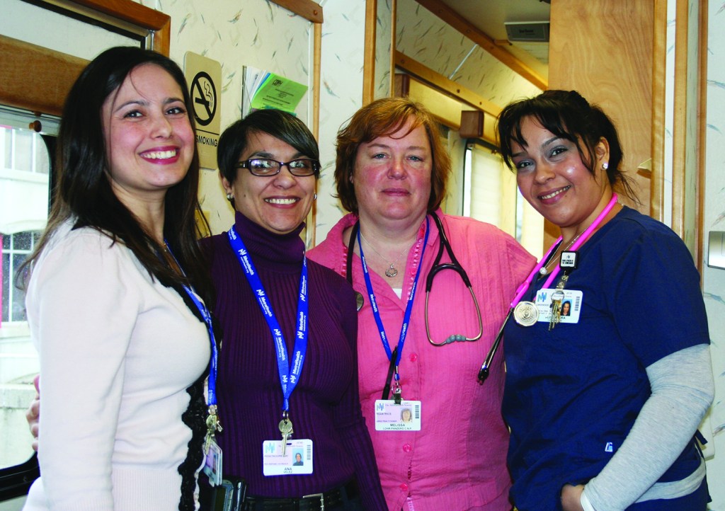 PHOTO BY CHUCK HOVEN Thursday, March 20, 2014, MetroHealth System Teen Health Clinic, Lincoln West High School, Mobile Unit in North Parking lot: MetroHealth Teen Health Clinic staff members (L-R) Lisa Ramirez, Phd, Psychologist; Melissa Lohr-Panzero, CNP; Alexsandra Caraballo, MPA; and Ana Valez, Hispanic Liaison.