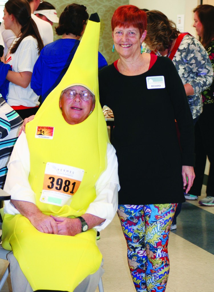 PHOTO BY CHUCK HOVEN Saturday, April 12, 2014; Be Your Own Hero 5KRace and 1 mile run, West Side Community House, W. 93rd and Lorain Avenue: Husband and wife, West Side Community House Volunteer Tom Buford dressed as a banana with West Side Community House Board member, Diane Fedak. 