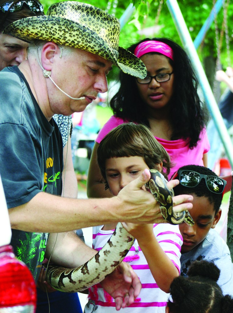 PHOTO BY CHUCK HOVEN Sunday, June 1st, 2014; West Park Summerfest, Jefferson Park, Lorain Avenue between W. 133 & W. 134th Streets: Children gather around Jungle Bob Tuma for a chance to get up close to a large snake.