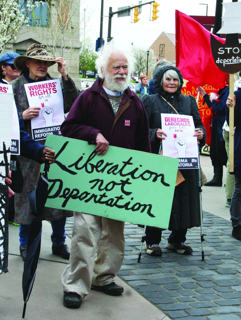 PHOTO BY CHUCK HOVEN Saturday, May 3, 2014; The Immigrant Justice Solidarity Rally and March organized by the Greater Cleveland Immigrant Support Network: Stewart Robinson is in the forefront carrying a sign saying “Liberation not Deportation” as supporters of immigrant rights begin a march from Market Square Park on W. 25th and Lorain Avenue, down W. 25th to Clark, down Clark to Fulton and back up Fulton to Lorain Avenue to the Catholic Worker Storefront at 42nd and Lorain Avenue. The demonstrators called for justice and compassion for immigrant families. 