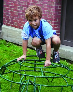 PHOTO BY DEBBIE SADLON Saturday, July 19, 2014; Literary Lots, Bridge Avenue between Fulton and W. 38th on the grounds of the Carnegie Branch of the Cleveland Public Library: William Garland, age 7, rides a sea turtle. Children listened to stories and played in the Literary Lot constructed with a sea and water theme. The Literary Lot will be open through August 9th. 