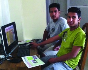 PHOTO BY KRISHNA DAHAL August 2014: Connecting Cleveland Editor Hari Kumar Dahal (forefront) and Managing Editor Ganga R. Dahal (rear) with an issue of Connecting Cleveland on the screen on their home computer. 