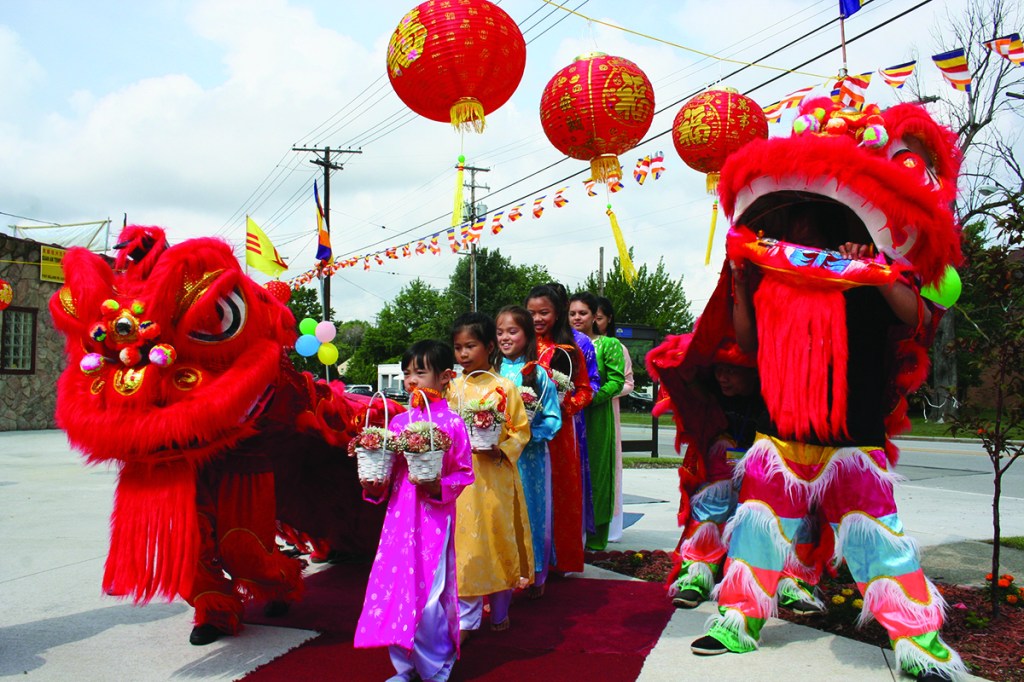 PHOTO BY CHUCK HOVEN Sunday, July 20, 2014; Celebration of 10th Anniversary of Quan Am Temple, 11921 Bellaire Road: Girls from the Quan Am Temple bring offerings of flowers to the Buddha during the ceremony: (Front to back): Lancy Nguyen, Rebecca McGinty, Lexie Lieu, Amanda To, Angela To, and Annie Nguyen.
