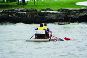 PHOTO BY DEBBIE SADLON Saturday, September 6, 2014, Great Lake Erie Boat Float, Cleveland Metroparks Edgewater Park: Habitat for Humanity staff members, Martin Carlton and Rebecca Smiddy sit in their chairs and paddle with snow shovels in the craft, the Habitanic. They won the prize for the most creative boat. 