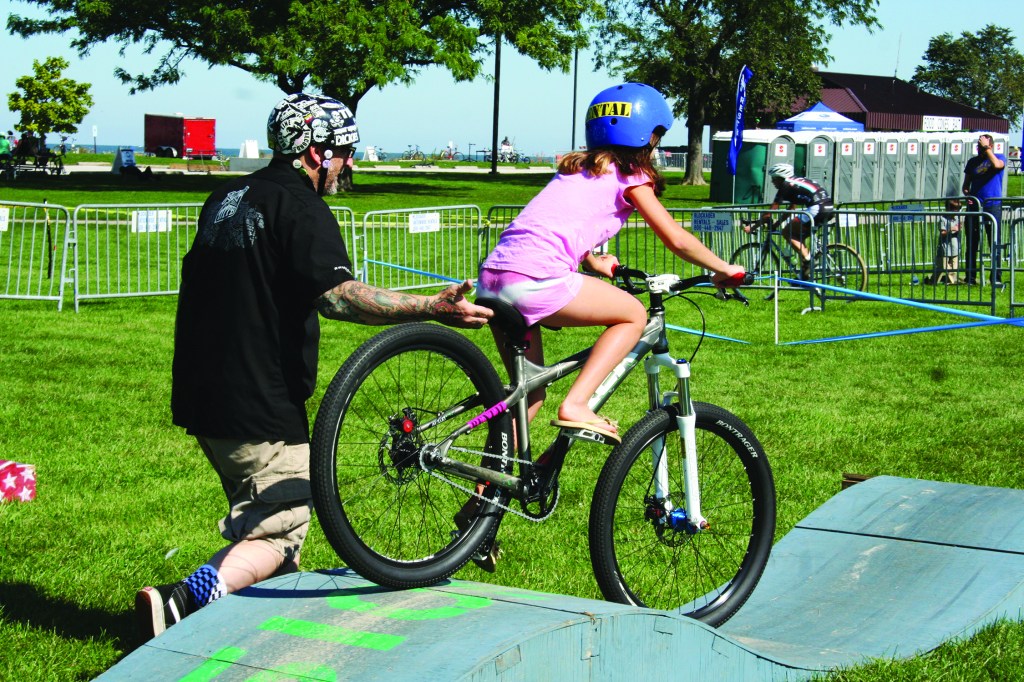 PHOTO BY DEBBIE SADLON Saturday, September 27th, 2014; Edgewater Park, Kids Zone, NEOCycle HUB event: Delaney McDaniel, age 9, of the West Boulevard neighborhood, tries out the track set up for the Kids Cruise.
