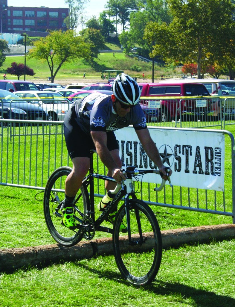 PHOTO BY DEBBIE SADLON Saturday, September 27th, 2014; Edgewater Park, Kids Zone, NEOCycle HUB event: A Cyclocross racer pedals along an obstacle filled track.