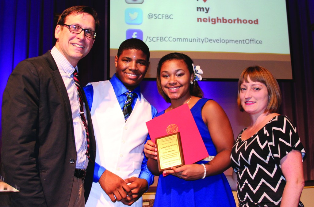 PHOTO BY CHUCK HOVEN Thursday, October 2, 2014; Stockyard, Clark-Fulton & Brooklyn Centre Community Development Office Annual Celebration, West 58th Street Church of God: Ward 14 Councilman Brian Cummins presents the Cleveland Junior Jitterbugs with a Community Spirit Award. To his immediate right are Junior World Lindy Hop Champions Cyle Dixon, age 17, and Alexis Davila, age 15, who entertained the crowd at the annual celebration by dancing the jitterbug. The pair, winners of the Junior International Lindy Hop Championship in Washington D. C. in August of 2014, are members of the Cleveland Junior Jitterbugs taught by instructor (far right) Valerie Salstrom at Archwood Church of Christ.