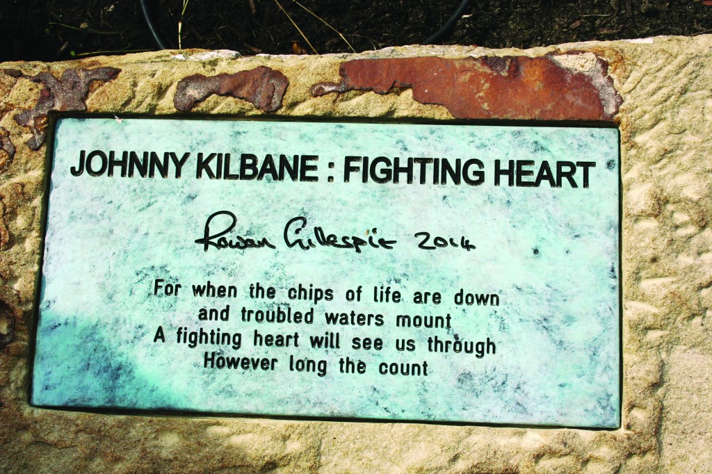 PHOTO BY ED TISHEL Sunday, September 28, 2014; The Irish American Archives Society’s dedication of the Johnny Kilbane Sculpture and Plaza, W. 74th and Fr. Frascati Drive, Battery Park: The plaque by the sculpture at Battery Park reads: JOHNNY KILBANE: FIGHTING HEART, Rowan Gillespie 2014, For when the chips are down and troubled waters mount A fighting heart will see us through However long the count.