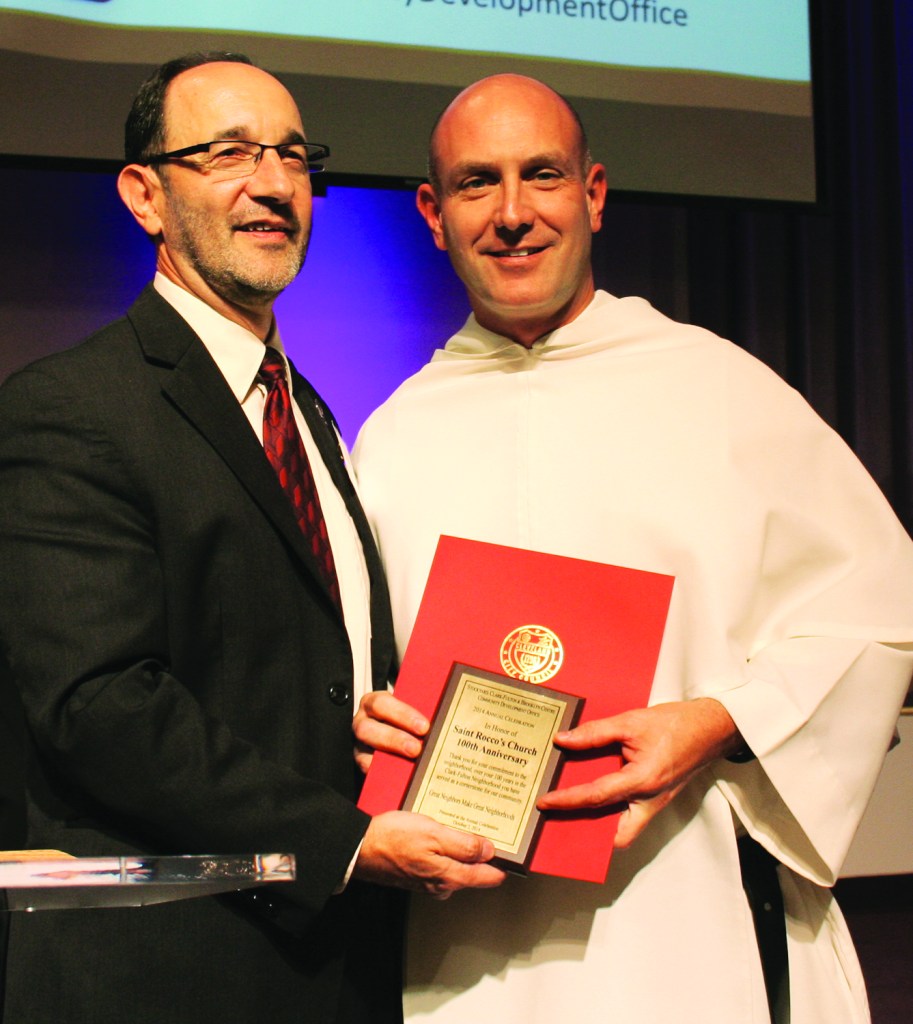 PHOTO BY CHUCK HOVEN Thursday, October 2, 2014; Stockyard, Clark-Fulton & Brooklyn Centre Community Development Office Annual Celebration, West 58th Street Church of God: Father James Mayer of St. Rocco Parish accepts an award from Ward 12 Councilman Tony Brancatelli honoring the church for hosting 100 years of Labor Day celebrations in the neighborhood.