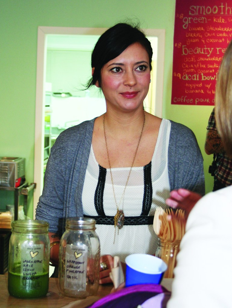 PHOTO BY CHUCK HOVEN Tuesday, December 9, 2014; Reception to announce grants to Gordon Square food businesses, Daily Press, 6604 Detroit Avenue: Daily Press owner Jodi Rae Santosusso serves up some cold-pressed juice. 