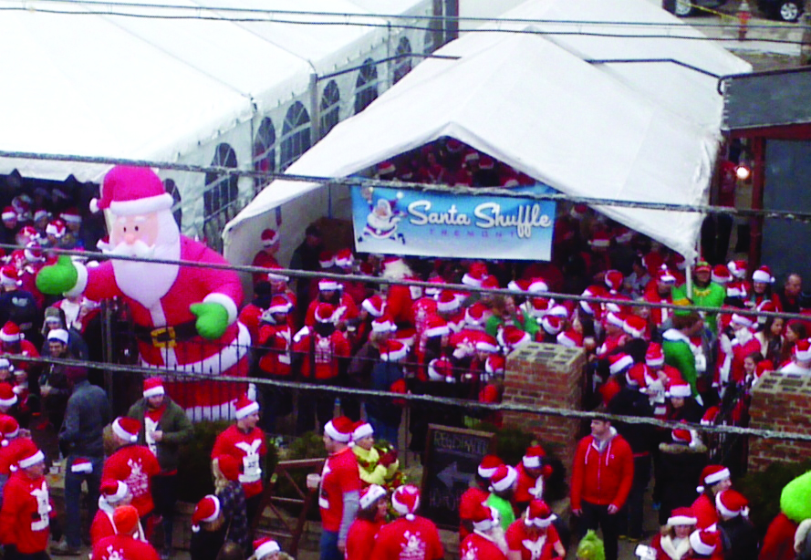 PHOTO BY HENRY SENYAK Saturday, December 13, 2014; Santa Shuffle, Tremont Tap House, 2475 Scranton Road: Runners dressed in Santa suites gathered outside the Tremont Tap House for the Santa Shuffle. The event, which helps to sponsor Tremont West Development Corporation’s free community events, included a two-hour bar crawl, a one-mile race and a post race party. 