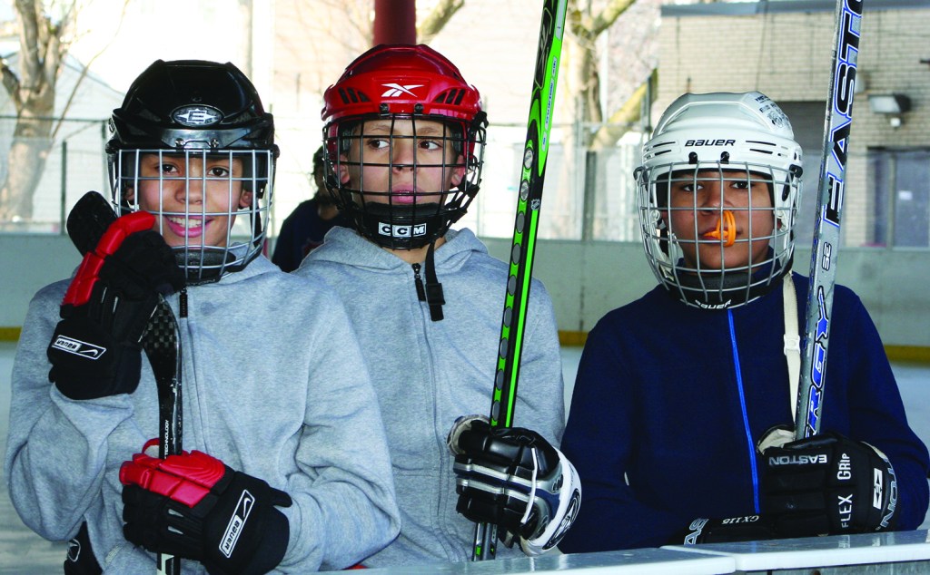 PHOTO BY DEBBIE SADLON Saturday, January 17, 2015; Halloran Park Skating Rink, 3550 W. 117th Street: Three members of the Halloran Huskies Hockey Team take time out from practice to pose for a picture. 