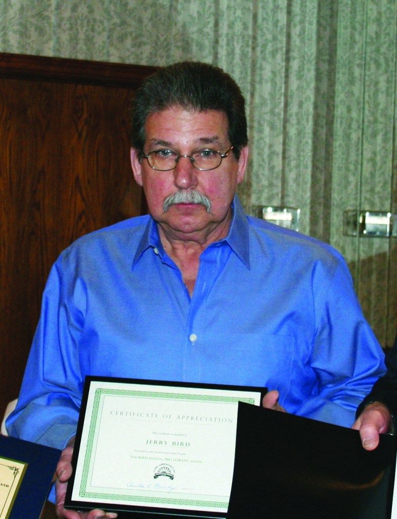 PHOTO BY CHUCK HOVEN Wednesday, January 21, 2015; Cudell Improvement’s 40th Annual Meeting, Brennan’s Banquet Center, 13000 Triskett Road: Jerry Bird, owner of Cleveland Uniform, receives the Storefront Renovation Award for work on the Bird Building at 9861 Lorain Avenue. 