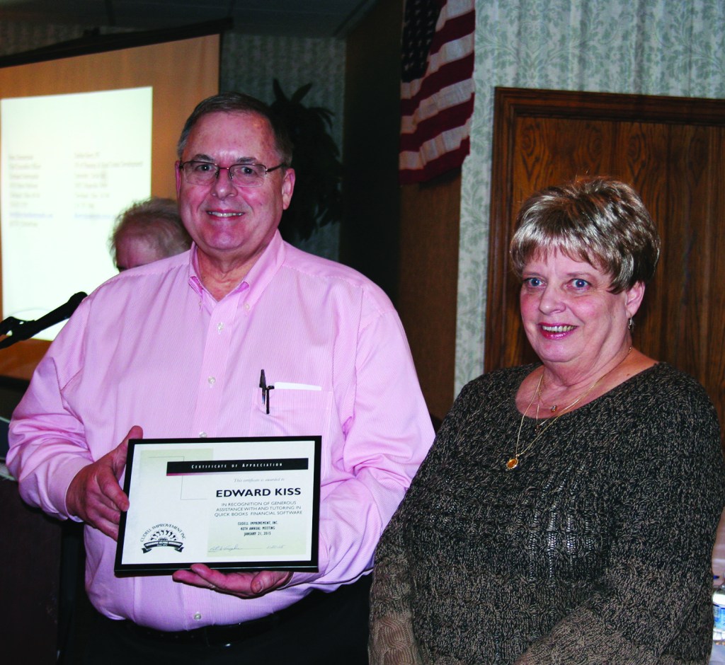 PHOTO BY CHUCK HOVEN Wednesday, January 21, 2015; Cudell Improvement’s 40th Annual Meeting, Brennan’s Banquet Center, 13000 Triskett Road: Volunteer Edward Kiss (L) received the Service Award for his work in assisting Cudell Improvement staff member Pat Konopka (R) in setting up contracts and grants on QuickBooks. 