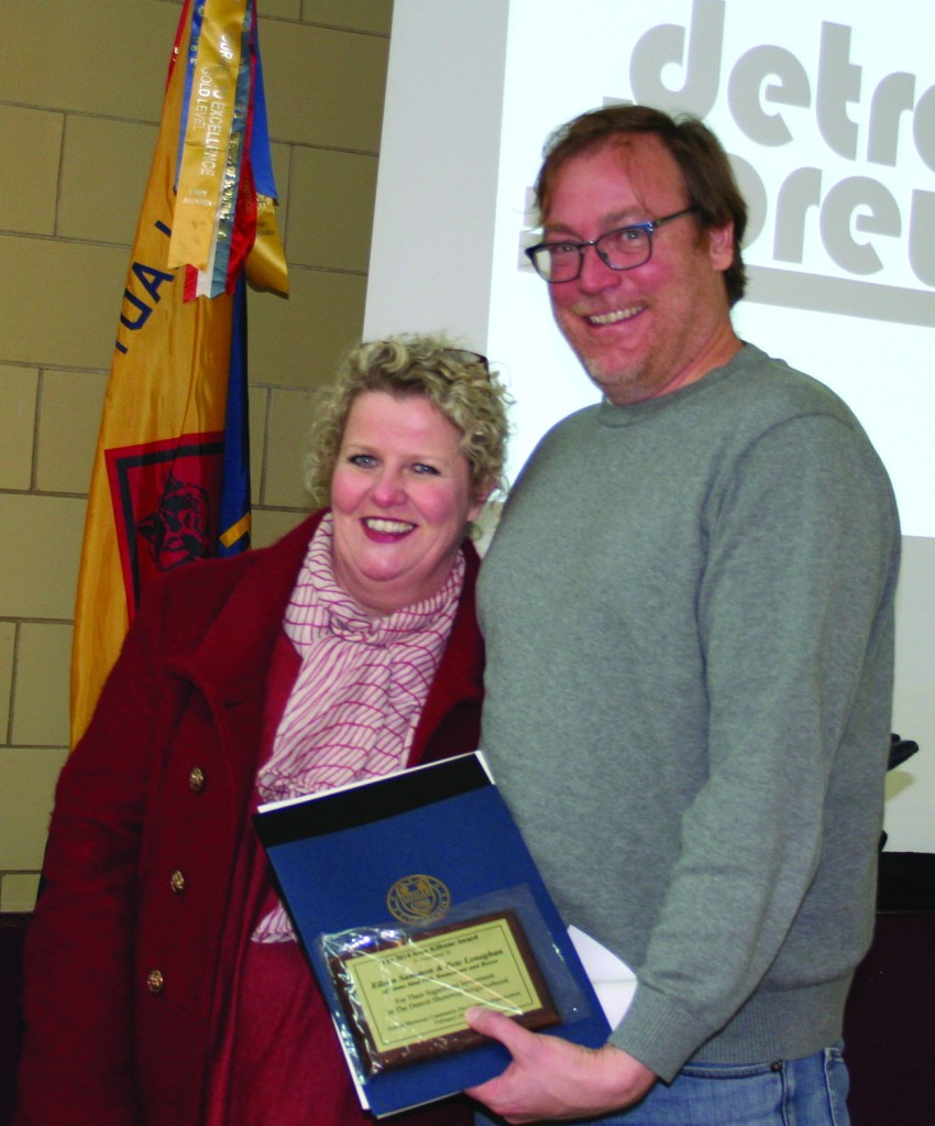 PHOTO BY CHUCK HOVEN Thursday, February 26, 2015; Detroit Shoreway Community Development Organization 41st Annual Meeting, Our Lady of Mt. Carmel Church Pope John Hall: Stone Mad co-owners Eileen Sammon and Pete Leneghan accept the Sean Kilbane Award for their contribution to the entertainment offerings in the neighborhood. Happy Dog owner Sean Watterson presented the award in memory of the late Happy Dog co-owner Sean Kilbane.