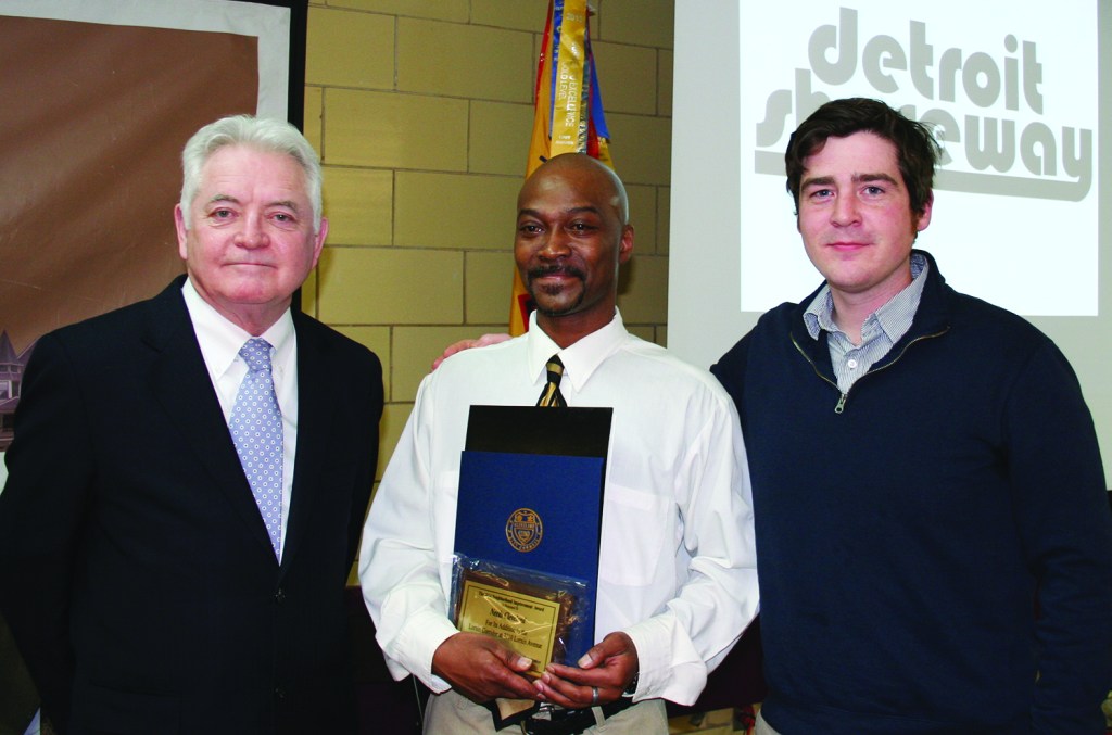PHOTO BY CHUCK HOVEN Thursday, February 26, 2015; Detroit Shoreway Community Development Organization 41st Annual Meeting, Our Lady of Mt. Carmel Church Pope John Hall: (L-R) Cuyahoga County Council President Dan Brady presents a Neighborhood Improvement Award to Phil Hicks and Macklin Barry of Needs Cleveland at 7710 Lorain Avenue. The organization, started by Bill and Alison Ripcho of Ripcho Studio, offers clothing and other donated household items to Cleveland residents in need.