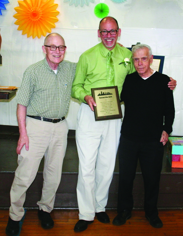 PHOTO BY DEBBIE SADLON Sunday, May 17, 2015; Reception and Luncheon for Pastor Allen V. Harris, Franklin Circle Church, 1688 Fulton Road: St. Patrick’s Church Pastor Rev. Mark DiNardo (R) and Deacon Bill Merriman (L) present Rev. Allen Harris with a plaque from the Shared Ministry. Harris and Franklin Circle Church actively participated in Shared Ministry, which offers a variety of services to neighborhood residents.