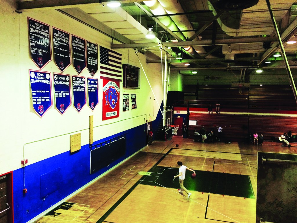 Photos By Melissa Fuentes  Pendants on the gymnasium wall trace the history of Lincoln-West's sports teams. 