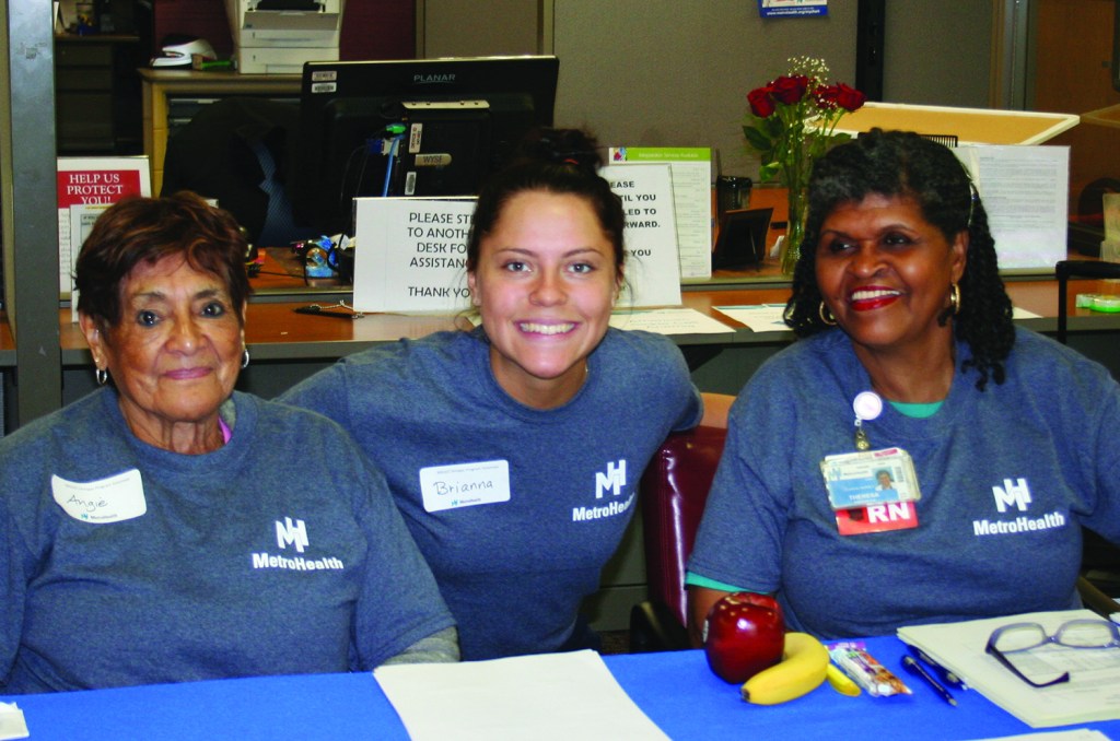 PHOTO BY DEBBIE SADLON Saturday, June 6, 2015, My MetroHealth, My Community Family Festival, MetroHealth Medical Center, corner of W. 25th and MetroHealth Drive: Volunteers Angie Garcia (Left) and Brianna Shagovac (Center) offer translation services while MetroHealth RN Teresa Simpson (Right) signs people in for free health screenings.