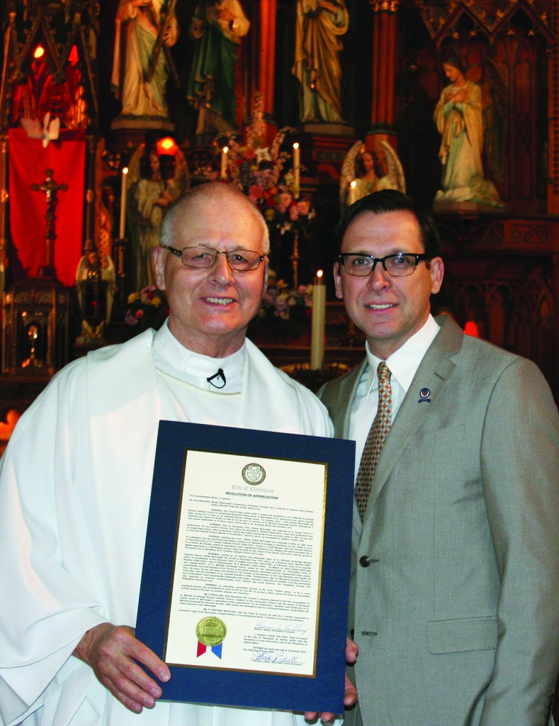 PHOTO BY CHUCK HOVEN Sunday, June 7, 2015; St. Michael Archangel Parish, 3114 Scranton Road: Ward 14 Councilman Brian Cummins presents Reverend Father James McCreight with a proclamation from Cleveland City Council for his service to St. Michael’s Parish. McCreight is retiring after 47 years as a priest – thirty-eight of those years were served at St. Michael’s Parish, the last 12 as pastor. St. Michael’s parishioners sang “May the Lord always bless you and keep you” at the Sundays masses and held receptions after the masses to offer Father McCreight best wishes for a happy retirement. 