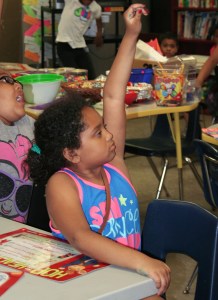 PHOTO BY DEBBIE SADLON Tuesday, July 21, 2015; Boys and Girls Club Walton School Site, 3409 Walton Ave: Dortha Montgomery raises her hand, eager to answer a question from Instructor Shirlann Lawson about the meaning of a sentence. 