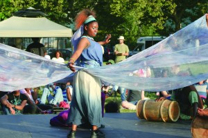 PHOTO BY DEBBIE SADLON Tuesday, August 4th, 2015; Cleveland Public Theatre’s Student Theatre Enrichment Program performance of an original new play, Lost in the Water, Herman Park, W. 58th and Herman Avenue: Dezbezisa, the River Goddess (portrayed by Dezhanay Simmons) rewards Selekana (portrayed by Tasheania Lee) with gifts for her good deeds. 