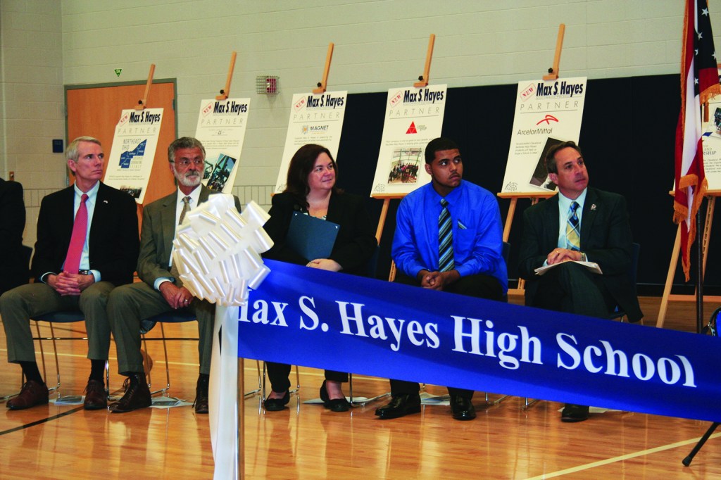 PHOTO BY DEBBIE SADLON Monday, August 31, 2015; Max S. Hayes High School Ribbon Cutting Ceremony, 2211 W. 65th Street: (L-R) United States Senator Rob Portman, Cleveland Mayor Frank Jackson, Max Hayes Principal Kelly Wittman, Max Hayes Student Malik Mims, and Cleveland Ward 15 Councilman Matt Zone listen as speakers talk about the opening of the new Max Hayes, and the opportunities it will offer for students.