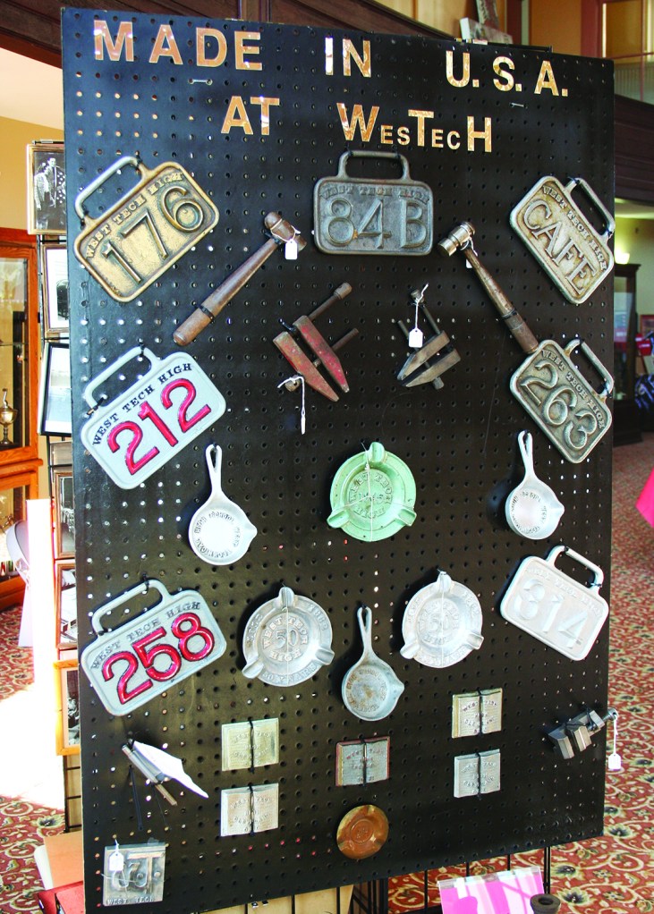PHOTO BY DEBBIE SADLON Thursday, October 15, 2015; West Tech Alumni Association Museum, First Floor Auditorium, 2201 W. 93rd: Hall Passes and other items made in the West Tech foundry are on display. Museum Curator Bonnie Dangler, Class of 1964, says alumni, often not wishing to reveal their names, brought the wayward passes to the museum. While the alumni may feel guilty for having kept their own get out of class free pass, Dangler says she is glad to obtain these precious pieces of West Tech history.