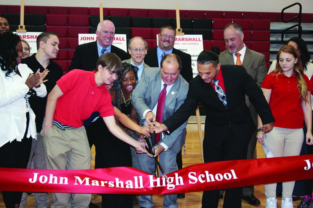 PHOTO BY DEBBIE SADLON Thursday, September 24, 2015; John Marshall High School Ribbon Cutting Ceremony, 3952 W. 140th Street: Cleveland Metropolitan School District Chief Executive Officer Eric Gordon joins with 12th grade students Da’Jzhanae Smith and Kevin Gramajo to cut the ribbon. 